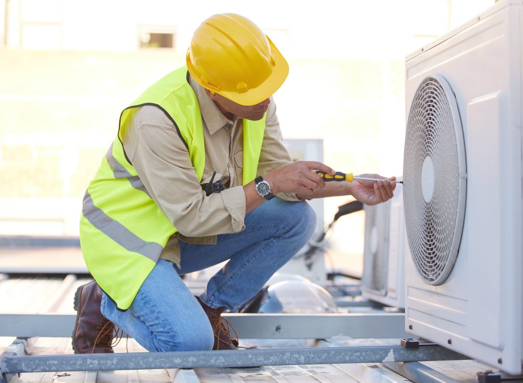 Air conditioningtechnician on roof for maintenance